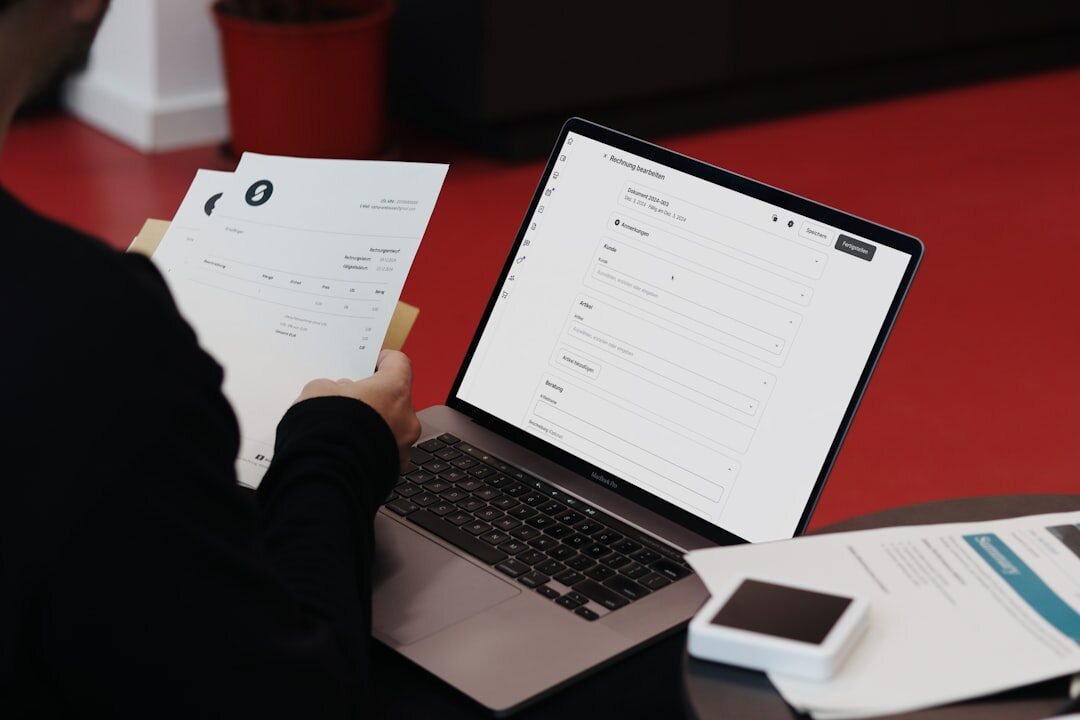Person reviewing notes and a laptop for a local report